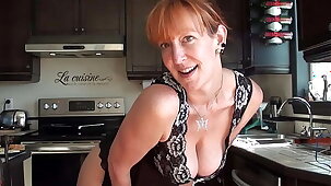 Cute redhead milf cooking with the addition of teasing us